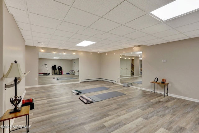 50 Hedgerow Ln, Manalapan, NJ 07726 - workout room with wood finished floors, baseboards, a drop ceiling, and a baseboard radiator