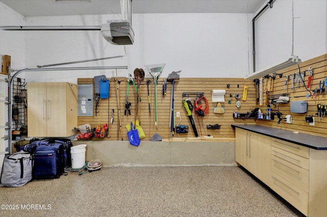 50 Hedgerow Ln, Manalapan, NJ 07726 - garage featuring a workshop area, wooden walls, a garage door opener, and electric panel