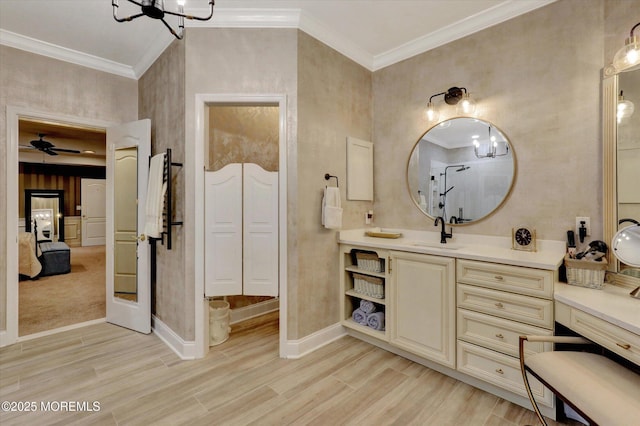 50 Hedgerow Ln, Manalapan, NJ 07726 - bathroom with ornamental molding, baseboards, wood finished floors, vanity, and a chandelier