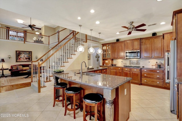 50 Hedgerow Ln, Manalapan, NJ 07726 - kitchen with ceiling fan, a sink, appliances with stainless steel finishes, brown cabinets, and light tile patterned floors