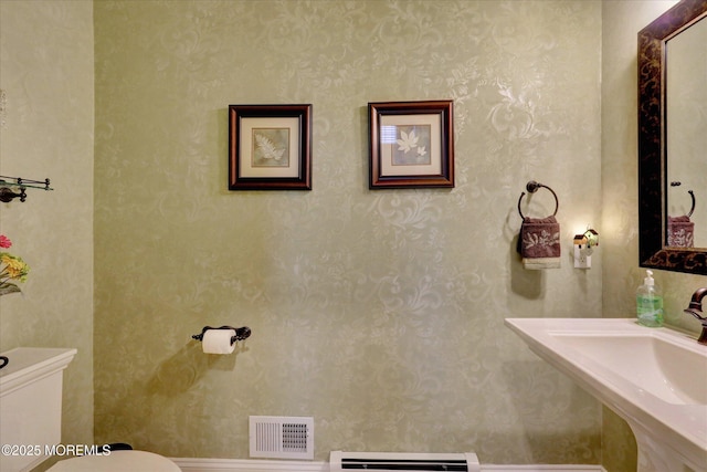 50 Hedgerow Ln, Manalapan, NJ 07726 - bathroom featuring toilet, a baseboard radiator, a sink, and wallpapered walls