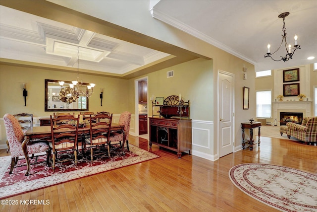50 Hedgerow Ln, Manalapan, NJ 07726 - dining space featuring a chandelier, a fireplace, hardwood / wood-style floors, crown molding, and coffered ceiling