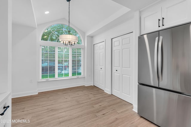 unfurnished dining area with a chandelier, lofted ceiling, light wood-style flooring, baseboards, and recessed lighting