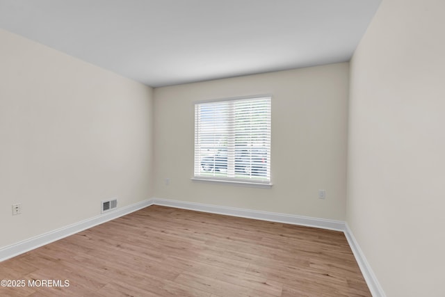 unfurnished room featuring light wood-style floors and baseboards