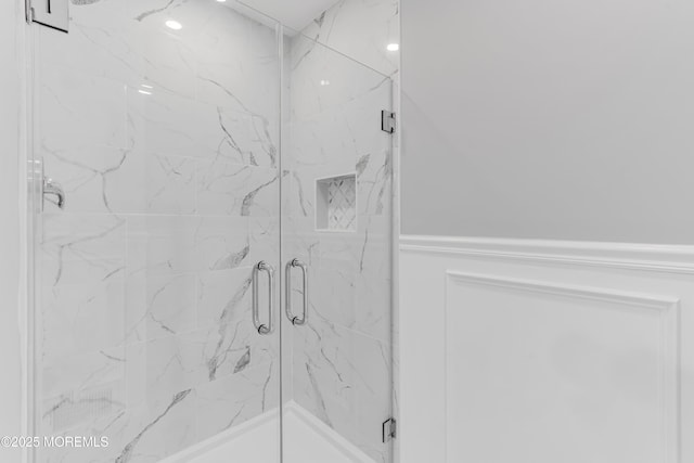 full bathroom featuring a marble finish shower