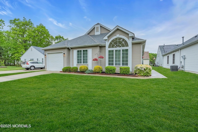 view of front of home with central air condition unit, concrete driveway, an attached garage, and a front lawn