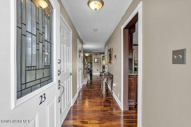 hall featuring wood finished floors, a textured ceiling, and baseboards