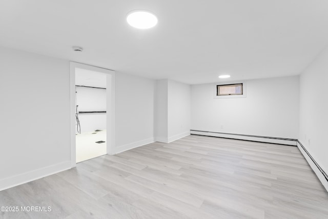 316 Hillside Dr, Neptune Township, NJ 07753 - basement featuring a baseboard heating unit, wood finished floors, and baseboards