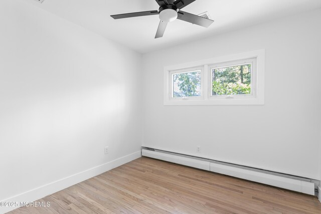 316 Hillside Dr, Neptune Township, NJ 07753 - empty room with a baseboard radiator, baseboards, wood finished floors, and a ceiling fan