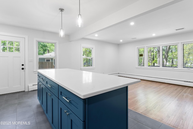 316 Hillside Dr, Neptune Township, NJ 07753 - kitchen with a baseboard heating unit, tile patterned floors, blue cabinets, a center island, and light countertops