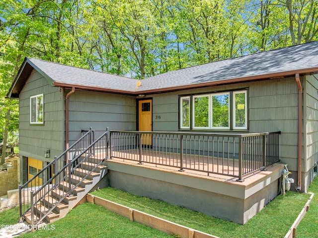 316 Hillside Dr, Neptune Township, NJ 07753 - view of front of property with a shingled roof, a deck, a front lawn, and stairway