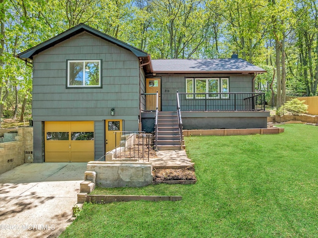 316 Hillside Dr, Neptune Township, NJ 07753 - view of front of house featuring a garage, concrete driveway, a front lawn, stairway, and roof with shingles