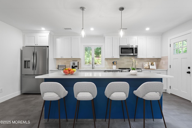 316 Hillside Dr, Neptune Township, NJ 07753 - kitchen with appliances with stainless steel finishes, a kitchen island, white cabinets, light countertops, and recessed lighting