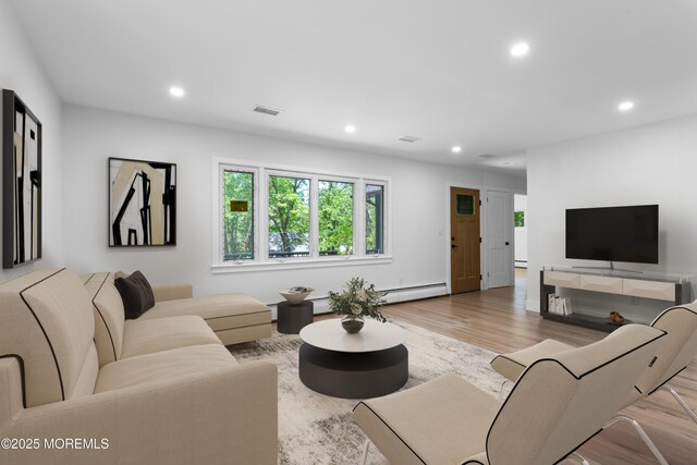 316 Hillside Dr, Neptune Township, NJ 07753 - living area with a baseboard heating unit, recessed lighting, and wood finished floors