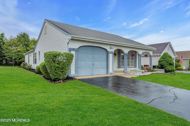 79 Mansfield Ave, Manchester, NJ 08759 - view of front of house with asphalt driveway, an attached garage, a front lawn, and roof with shingles