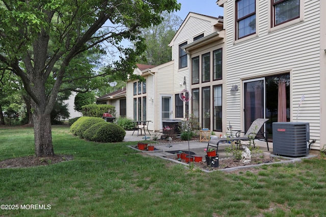 back of property featuring a patio area, cooling unit, and a lawn