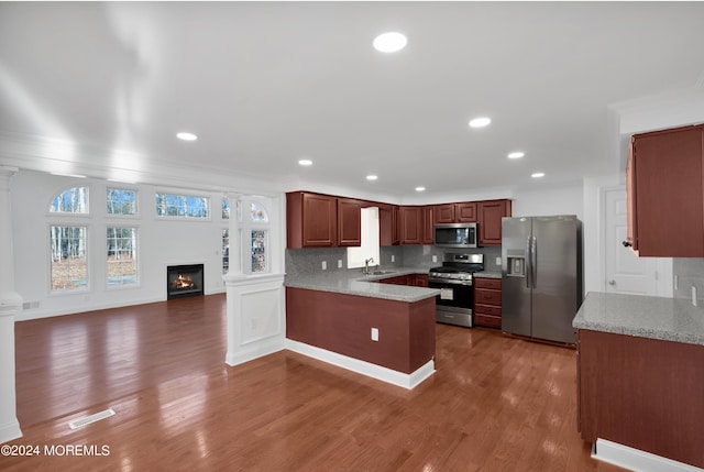 6 Afton Rd, Jackson, NJ 08527 - kitchen featuring stainless steel appliances, a peninsula, a sink, wood finished floors, and a lit fireplace