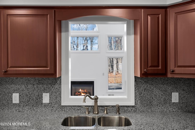 6 Afton Rd, Jackson, NJ 08527 - kitchen featuring a sink, light stone countertops, backsplash, and a glass covered fireplace