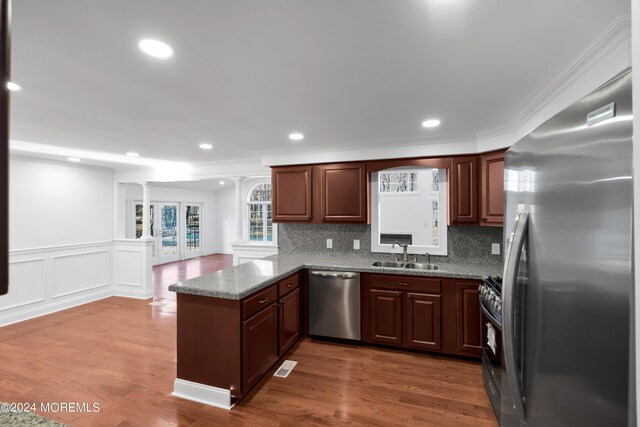 6 Afton Rd, Jackson, NJ 08527 - kitchen with stainless steel appliances, a sink, a peninsula, backsplash, and stone countertops