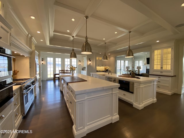 0 Wilson Cir, Rumson, NJ 07760 - kitchen featuring a large island with sink, coffered ceiling, stainless steel appliances, white cabinets, and a sink