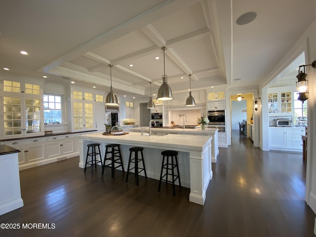 0 Wilson Cir, Rumson, NJ 07760 - kitchen with a large island with sink, white cabinetry, a kitchen breakfast bar, dark wood-style flooring, and coffered ceiling