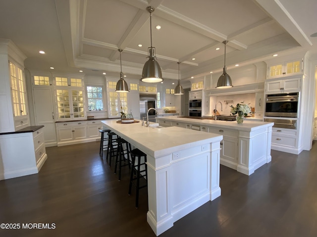 0 Wilson Cir, Rumson, NJ 07760 - kitchen with a large island with sink, a warming drawer, a sink, white cabinets, and dark wood-type flooring