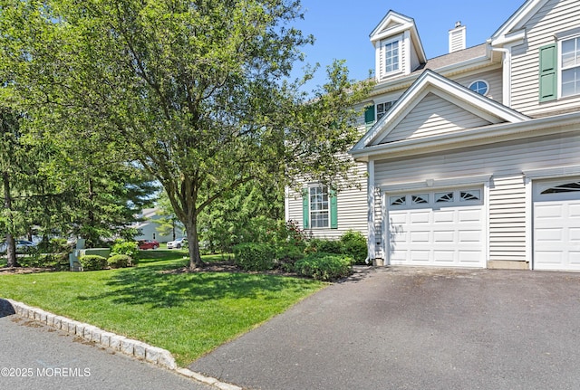 52 Straton Ct Unit 1006, Parlin, NJ 08859 - view of front facade with asphalt driveway, a front lawn, and a chimney