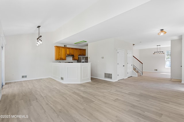 52 Straton Ct Unit 1006, Parlin, NJ 08859 - unfurnished living room with light wood finished floors, stairs, baseboards, and a chandelier