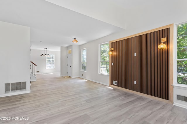 52 Straton Ct Unit 1006, Parlin, NJ 08859 - unfurnished living room featuring light wood-style flooring, stairway, healthy amount of natural light, and baseboards