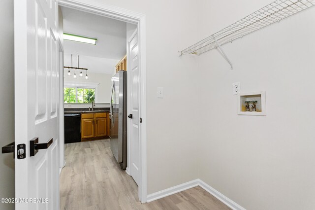 52 Straton Ct Unit 1006, Parlin, NJ 08859 - washroom with light wood-style flooring, hookup for a washing machine, and baseboards