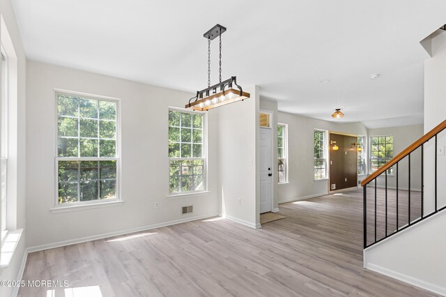 52 Straton Ct Unit 1006, Parlin, NJ 08859 - unfurnished dining area featuring wood finished floors, stairs, and baseboards