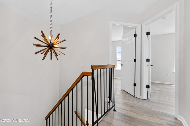 52 Straton Ct Unit 1006, Parlin, NJ 08859 - hall with a chandelier, an upstairs landing, light wood finished floors, and baseboards