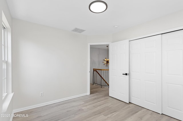 52 Straton Ct Unit 1006, Parlin, NJ 08859 - unfurnished bedroom featuring light wood finished floors, a closet, and baseboards