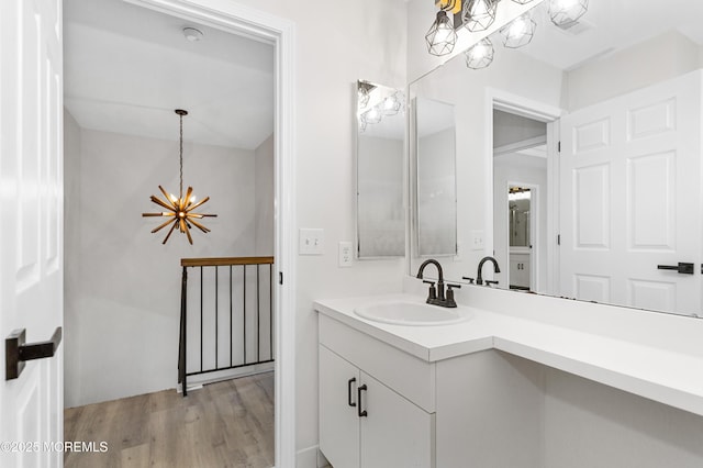 52 Straton Ct Unit 1006, Parlin, NJ 08859 - bathroom with a chandelier, wood finished floors, and vanity