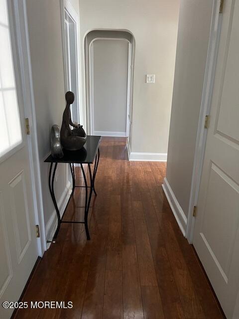 79 Davidson Mill Rd, North Brunswick, NJ 08902 - hallway featuring hardwood / wood-style flooring, baseboards, and arched walkways