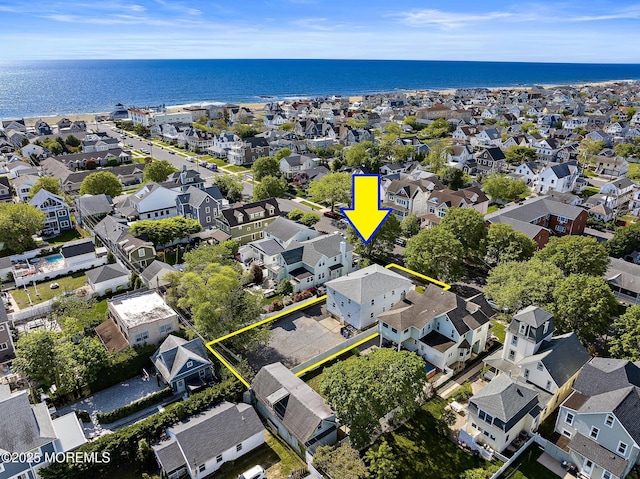 view of property location featuring property parcel outlined, nearby suburban area, and a large body of water