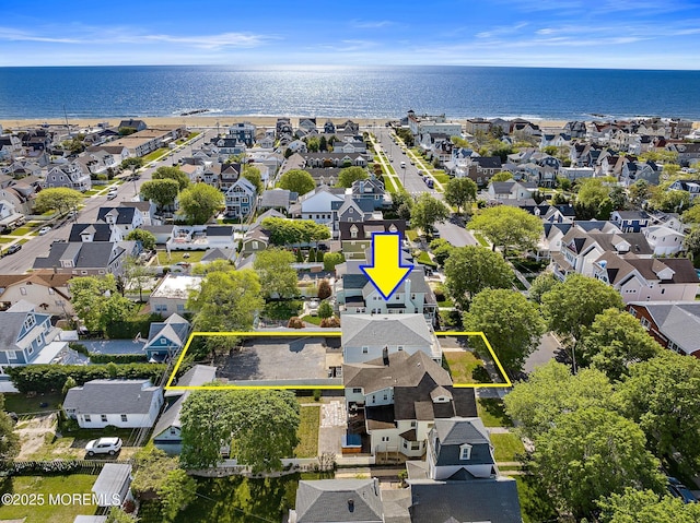 aerial perspective of suburban area featuring property parcel outlined and a nearby body of water