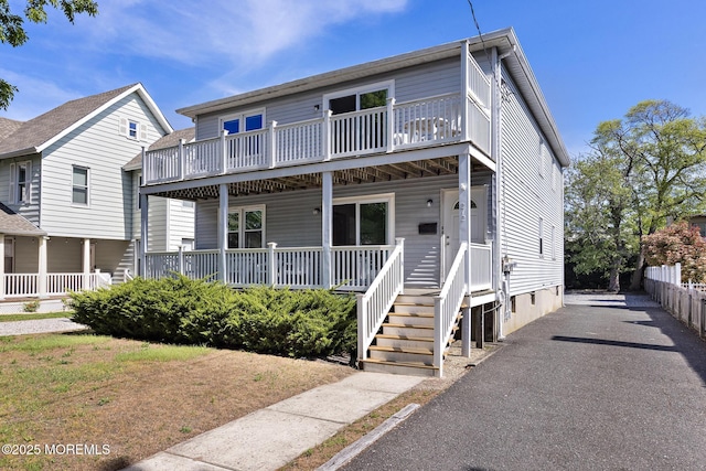 view of front of home with covered porch and a balcony