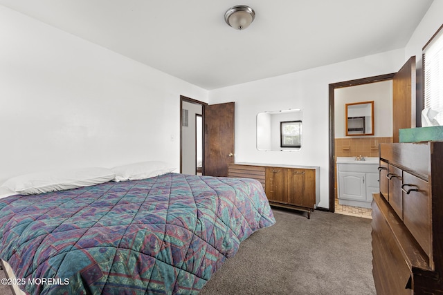 bedroom with carpet flooring and connected bathroom