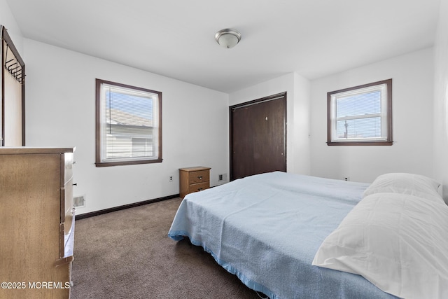 bedroom featuring carpet and baseboards