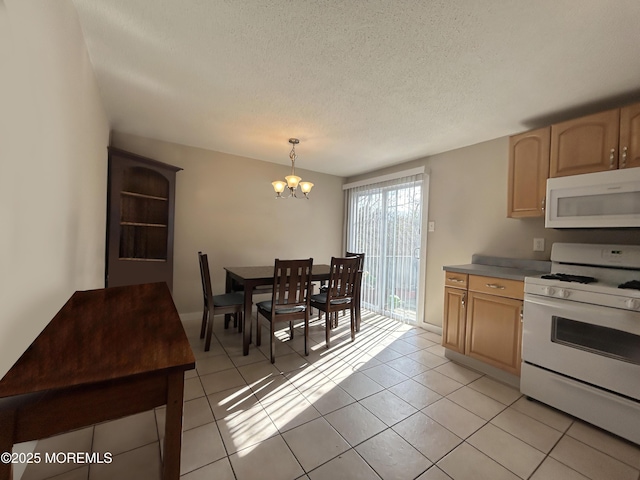 237 Falcon Dr, Little Egg Harbor, NJ 08087 - kitchen featuring white appliances, a chandelier, light tile patterned flooring, a textured ceiling, and hanging light fixtures