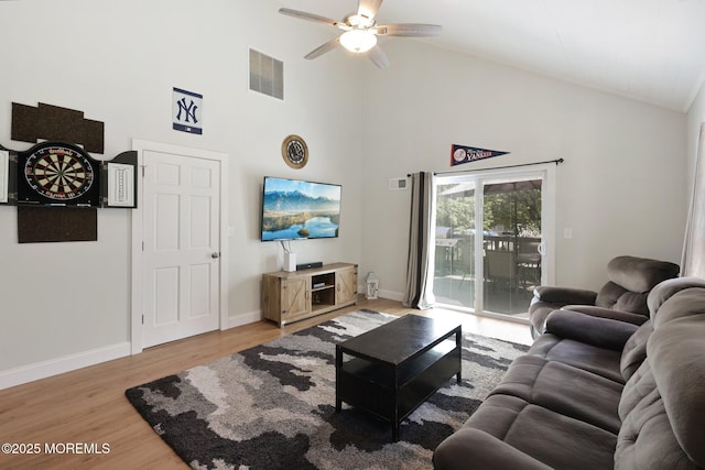 living area featuring high vaulted ceiling, ceiling fan, light wood finished floors, and baseboards