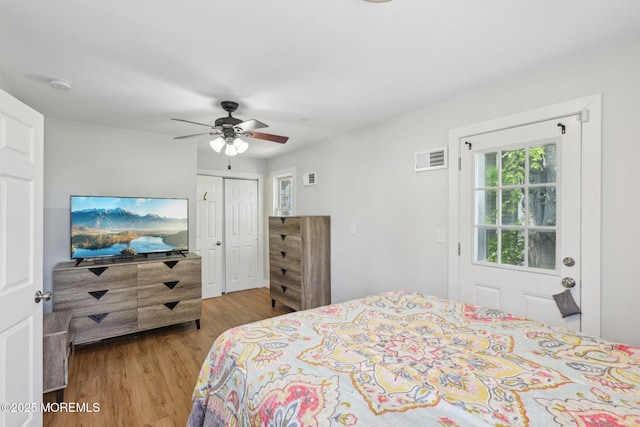 bedroom with light wood finished floors, a closet, and ceiling fan