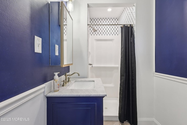 full bathroom featuring a stall shower and vanity