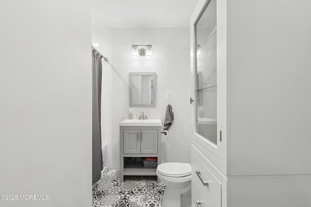 bathroom featuring tile walls, tile patterned floors, a shower with curtain, toilet, and vanity