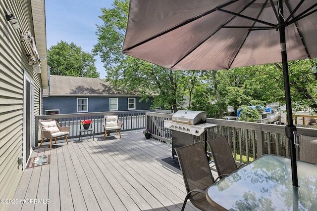 deck featuring outdoor dining space and a grill