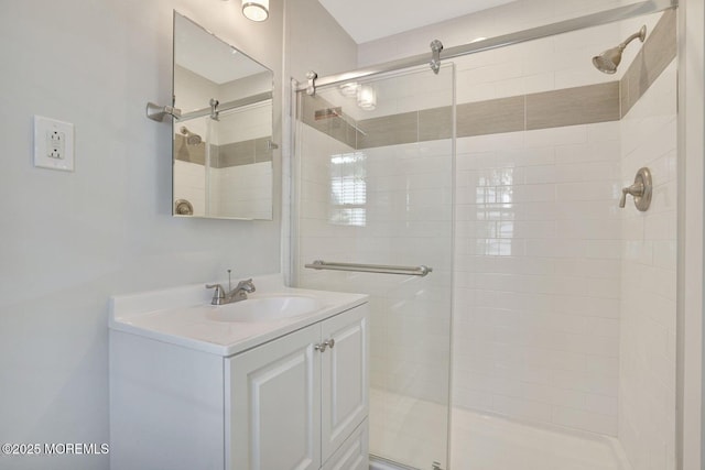 full bath with a stall shower and vanity