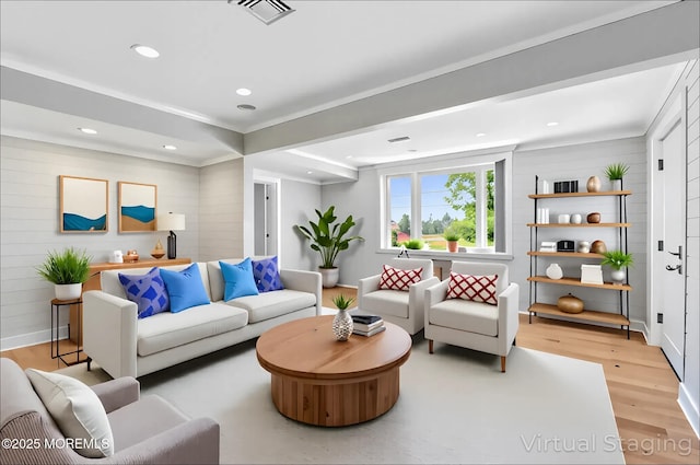living area with light wood-style floors, recessed lighting, and wood walls