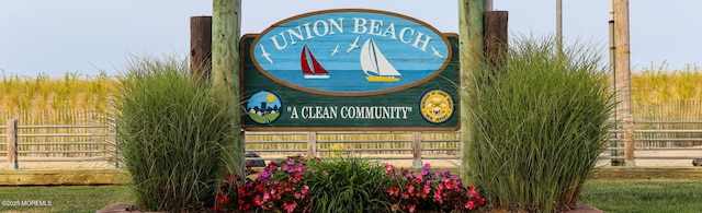community sign featuring fence