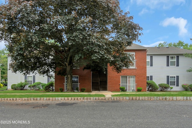 707 Zlotkin Cir Unit 7, Freehold, NJ 07728 - view of property hidden behind natural elements with brick siding and a front yard